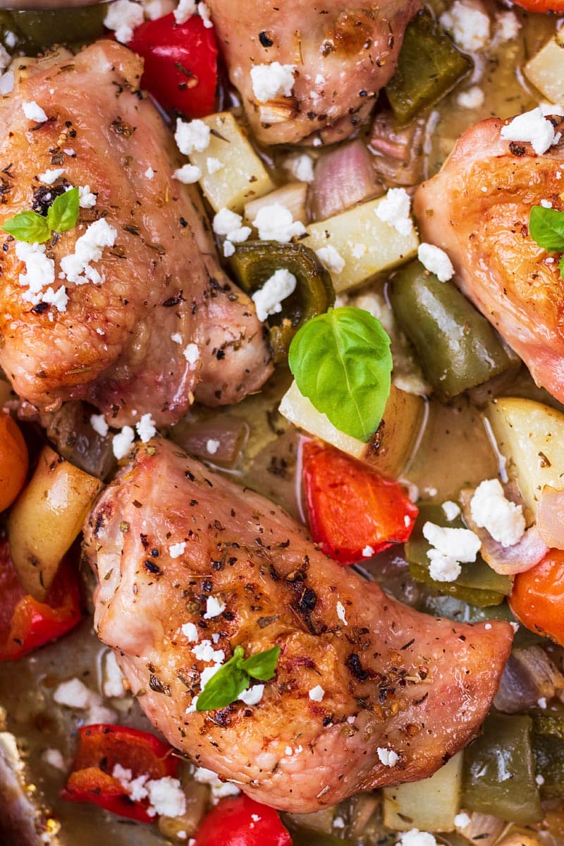 Baked chicken thighs in a sheetpan with chunks of vegetables